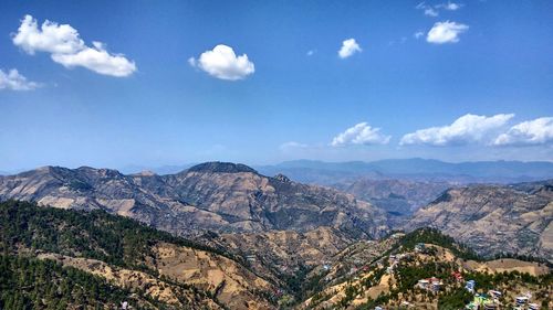 Scenic view of mountains against blue sky