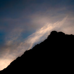 Low angle view of silhouette mountains against sky at sunset