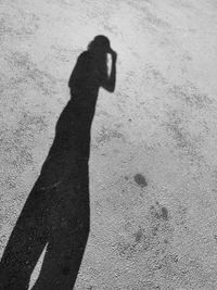 Shadow of person on road