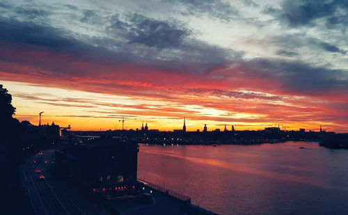 High angle view of river against dramatic sky during sunset