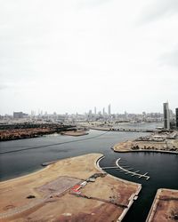 High angle view of river by buildings against sky