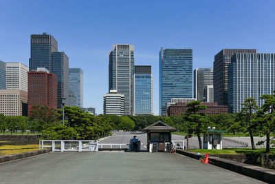 View of city buildings against clear sky