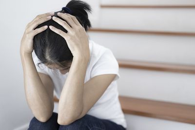 Midsection of woman sitting at home