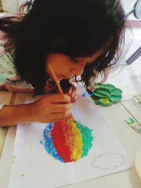 Cute girl holding multi colored toys