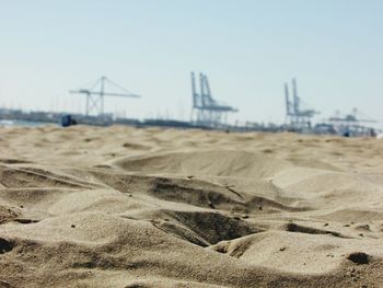 Close-up of sand dune against clear sky