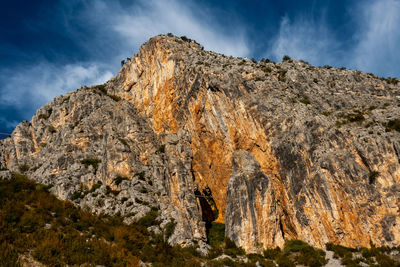 Low angle view of rock formation against sky