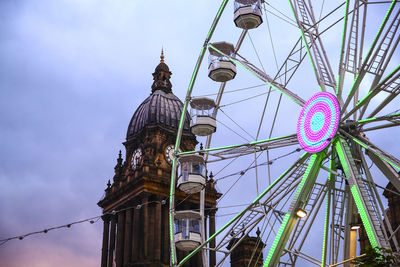 Leeds town hall and the observation wheel leeds at dusk