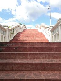 Low angle view of steps amidst buildings in town