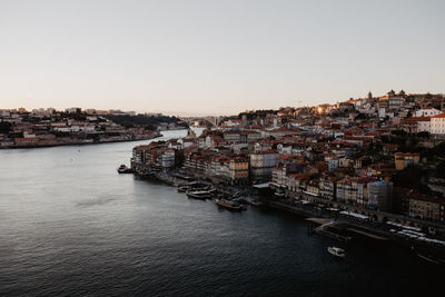 High angle view of townscape by sea against clear sky