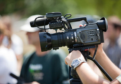 Close-up of man photographing camera