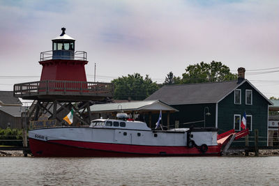 Traditional building by sea against sky