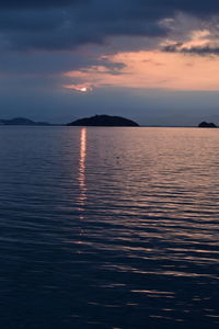 Scenic view of sea against romantic sky at sunset