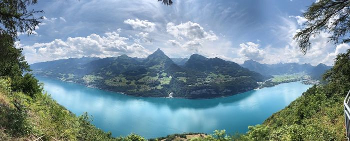 Panoramic view of river and mountains against sky