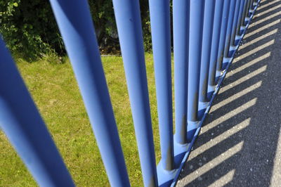 High angle view of railing by shadow in city