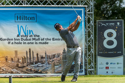 Full length of man jumping at sign