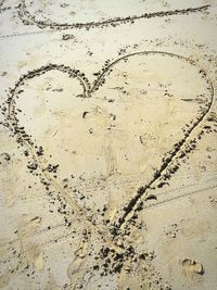 Close-up of heart shape on sand