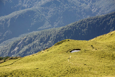 Scenic view of green landscape and mountains