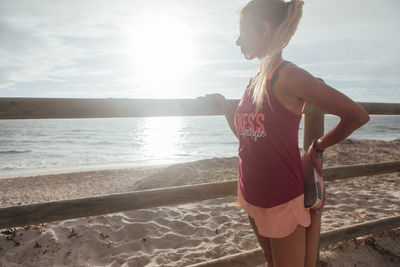 Rear view of woman standing on beach