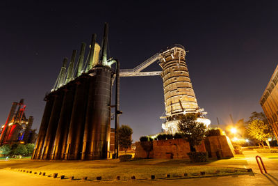 Low angle view of city lit up at night