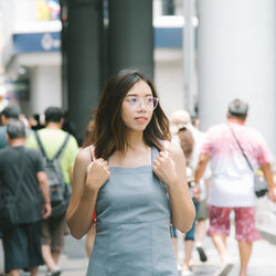 Woman with arms raised standing in hair