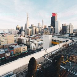 Aerial view of buildings in city against sky