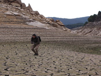 Full length of man walking on mountain against sky