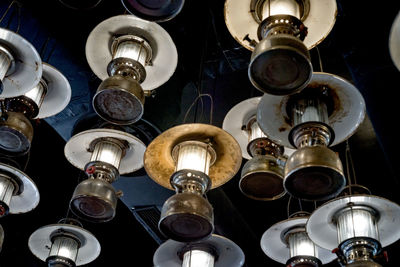 Low angle view of illuminated pendant lights hanging from ceiling