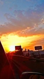 Cars on road at sunset