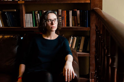 A portrait of a girl in front of the bookshelves