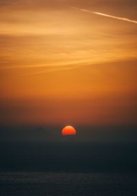 Scenic view of sea against romantic sky at sunset