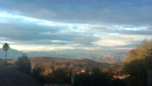 Scenic view of mountains against cloudy sky