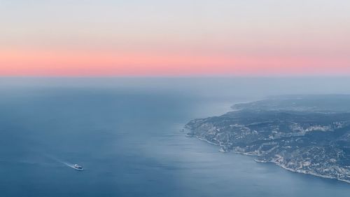 Aerial view of sea against sky during sunset