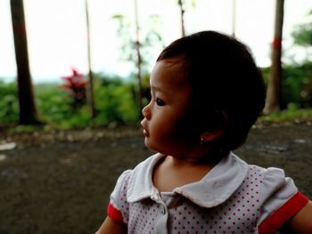 Cute baby girl looking away