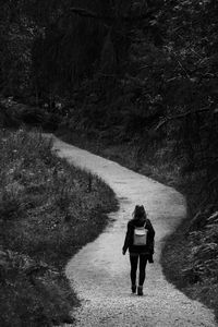 Rear view of woman walking on footpath in peak district, england, united kingdom