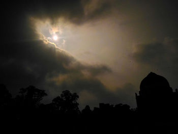 Silhouette trees against sky at night