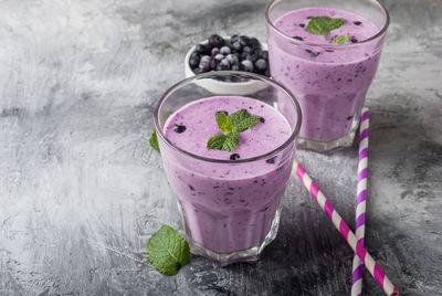 High angle view of smoothie in drinking glasses on table