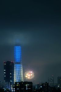 Low angle view of skyscrapers lit up at night