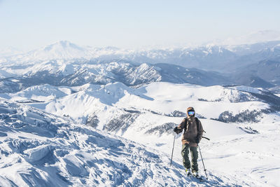 Full length of person on snowcapped mountains during winter