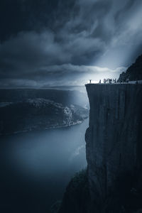 Scenic view of sea by cliff against sky