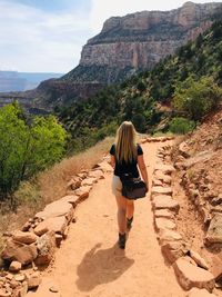 Rear view of woman walking on mountain