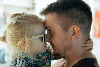 Dad and daughter looking at each other at night