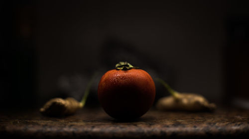 Close-up of tomato with gingers on kitchen counter at home