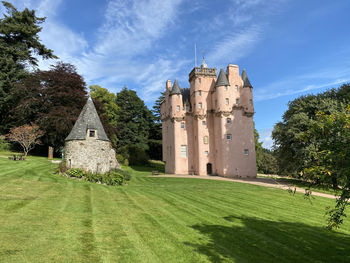 Historic building on field against sky