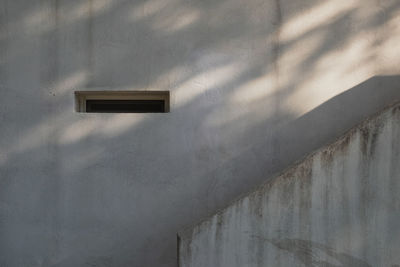 Low angle view of window on wall of building