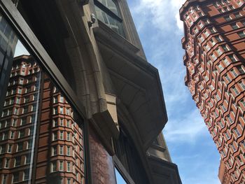 Low angle view of building against cloudy sky