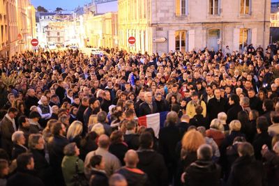 Crowd in alley amidst buildings