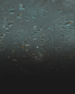 Full frame shot of raindrops on water