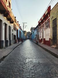 Empty alley amidst buildings in city