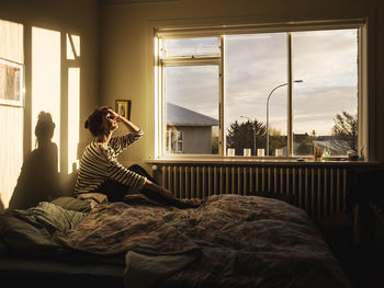 Rear view of man looking at camera