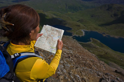 Woman holding umbrella on mountain